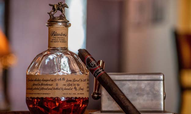 Bottle of Bourbon and a Cigar. The Essence of Tobacco Absolute Oil.