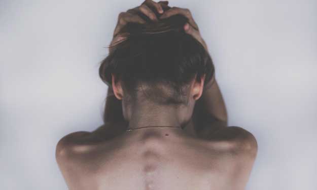 Woman Holding Head from Headache and How to Get Relief.