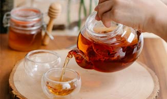Pouring Tea and Adding Honey for Cough Relief.