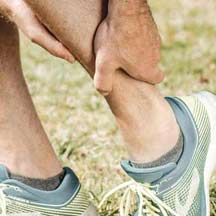 Person Holding a Painful Ankle