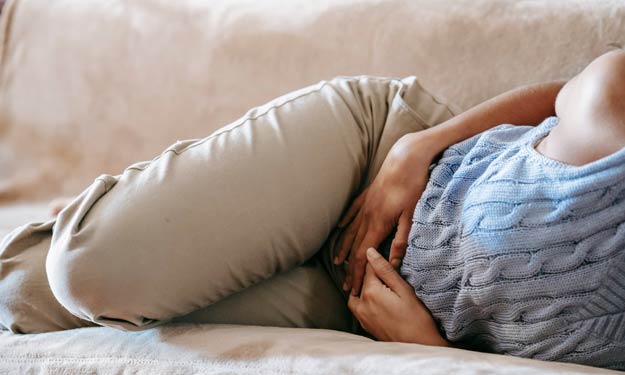 Woman With Water Retention Laying on Couch.